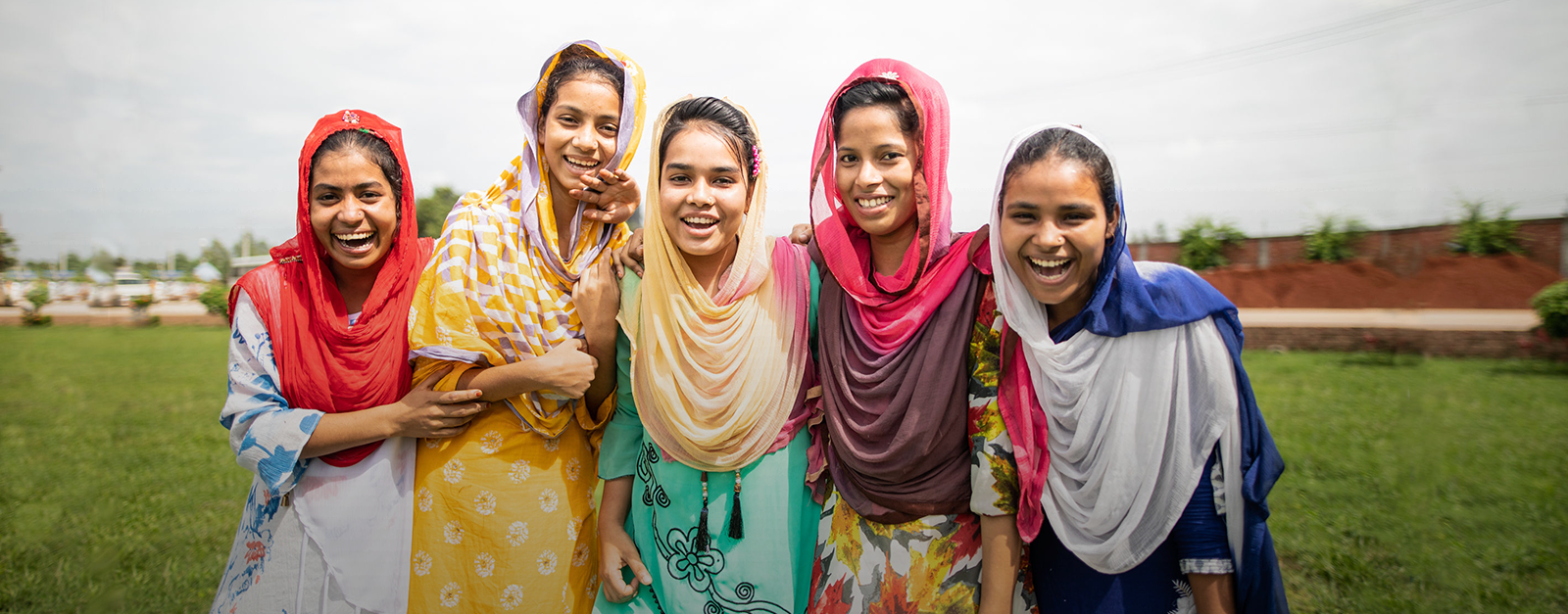 Walk in her Shoes logo. Image of girls laughing.